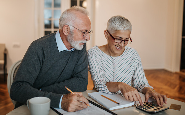 Happy couple calculating donations